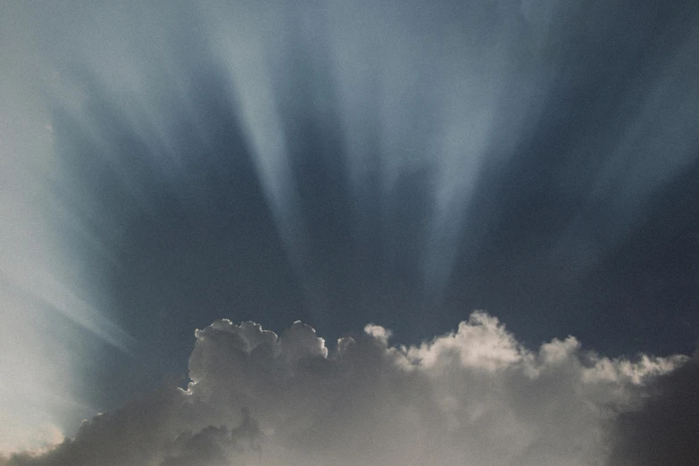 sun rays through cloud cover in the sky