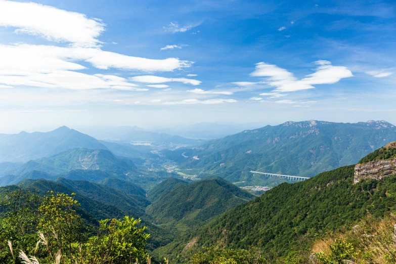 mountains are covered in green foliage in the distance