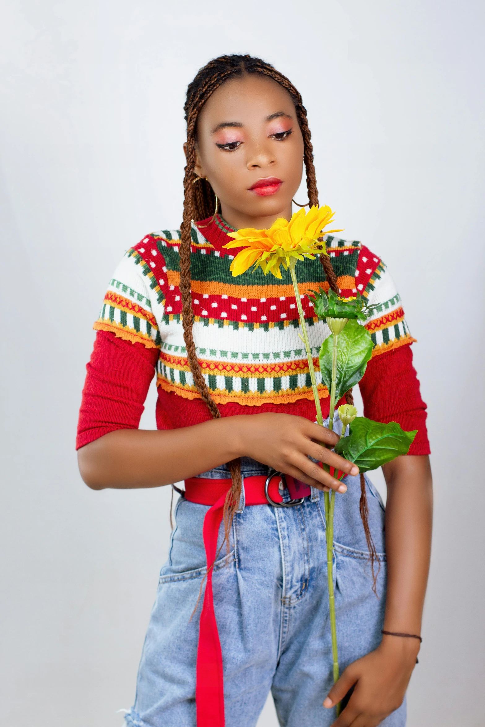 a young woman is holding onto her flower