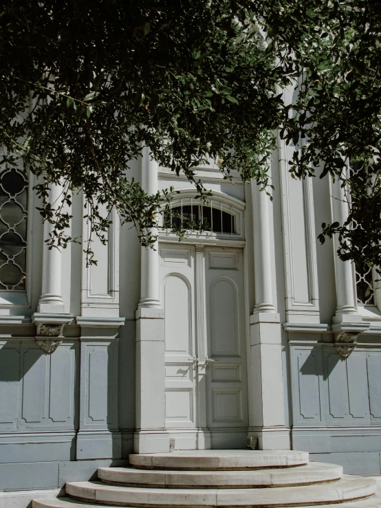 a staircase with two large arched doors to the side