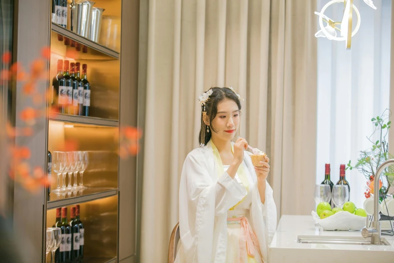 a young woman in a kimono stands in front of a counter