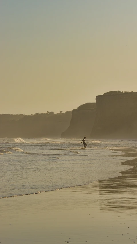 a person is holding a surfboard in the water