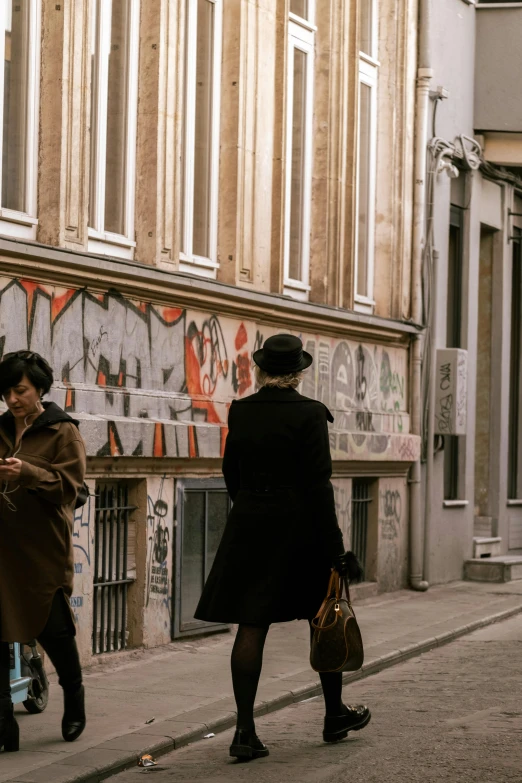 two people walking down a city street together