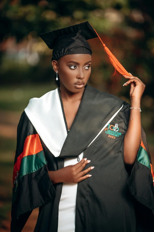 a young woman in a graduation robe and cap