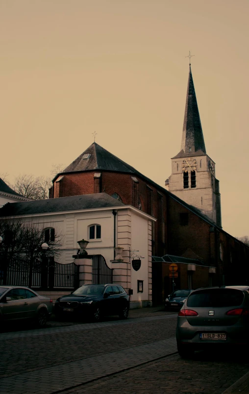 cars parked outside a church on a street