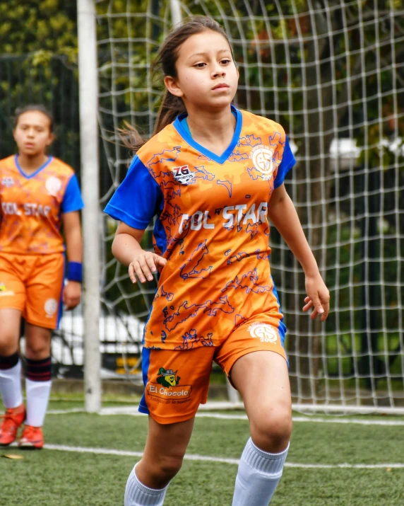 a  in an orange uniform during a soccer game