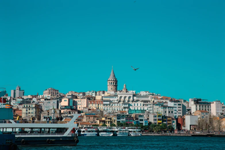 a beautiful city next to the water in front of boats