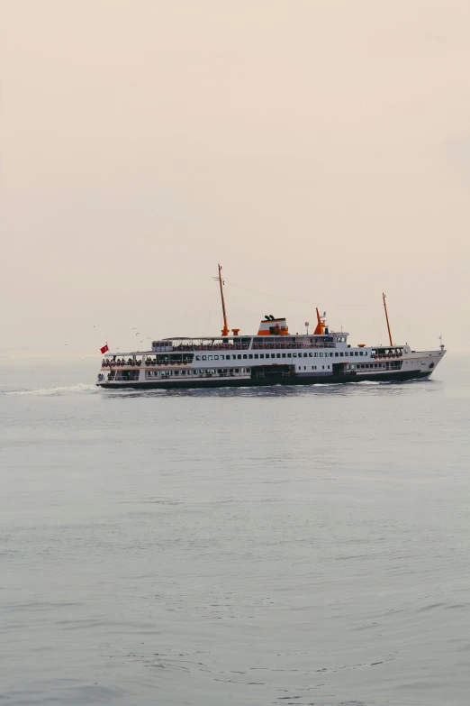 a large white boat on open water near shore