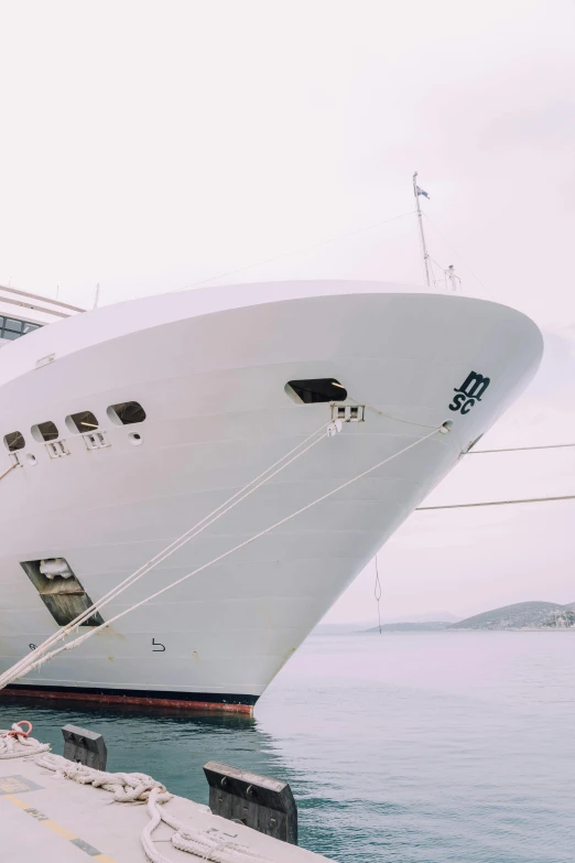 the large cruise ship has a rope attached to it's bow