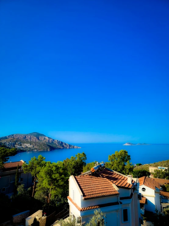 an overhead view of rooftops overlooking a large body of water