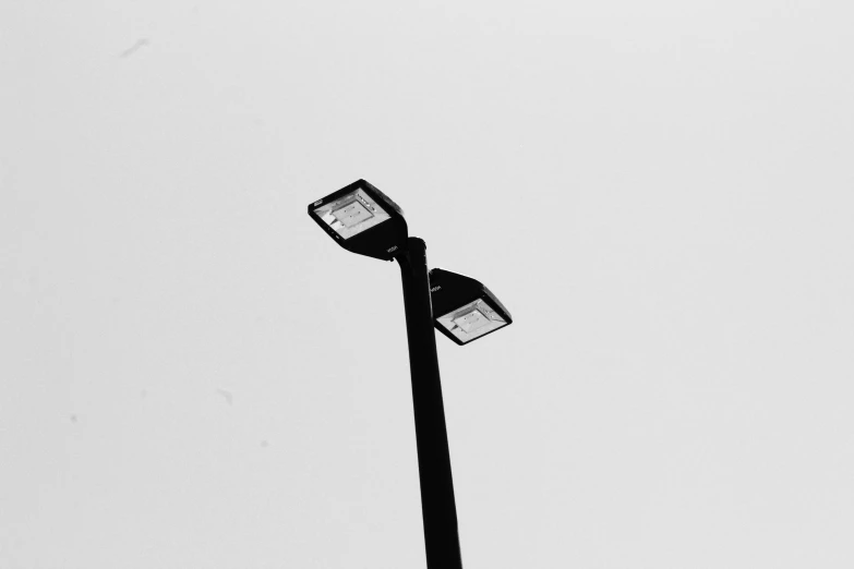 two street lamps, one on the pole and one on the ground