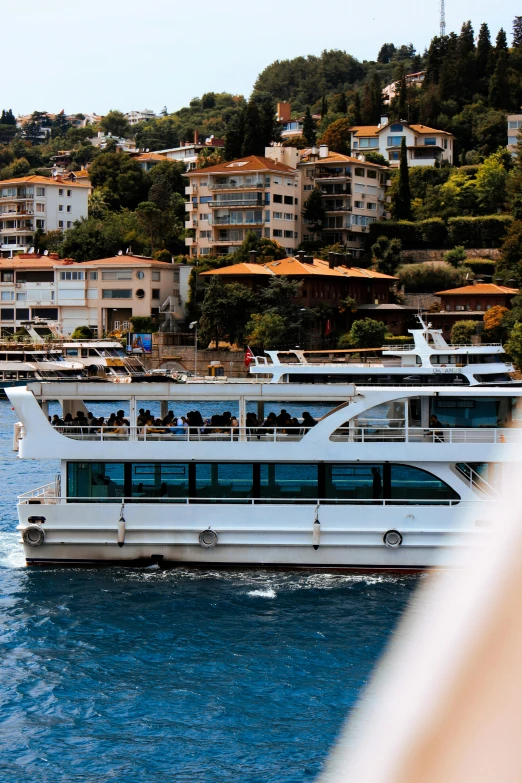 a white passenger boat traveling on the water