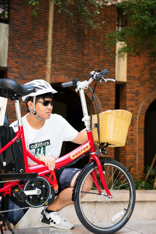 a man sitting on a bench by a bike