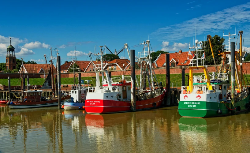 several boats docked near some buildings near a body of water