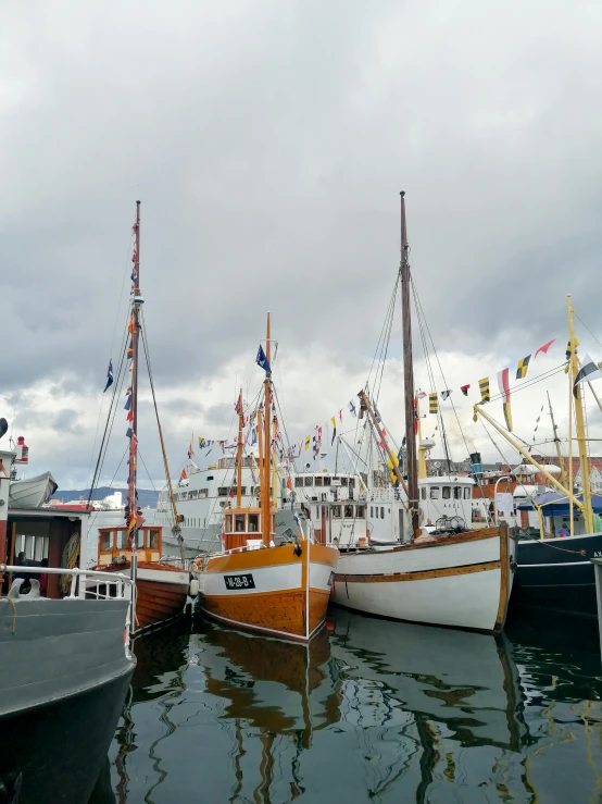 several boats docked near each other on a body of water