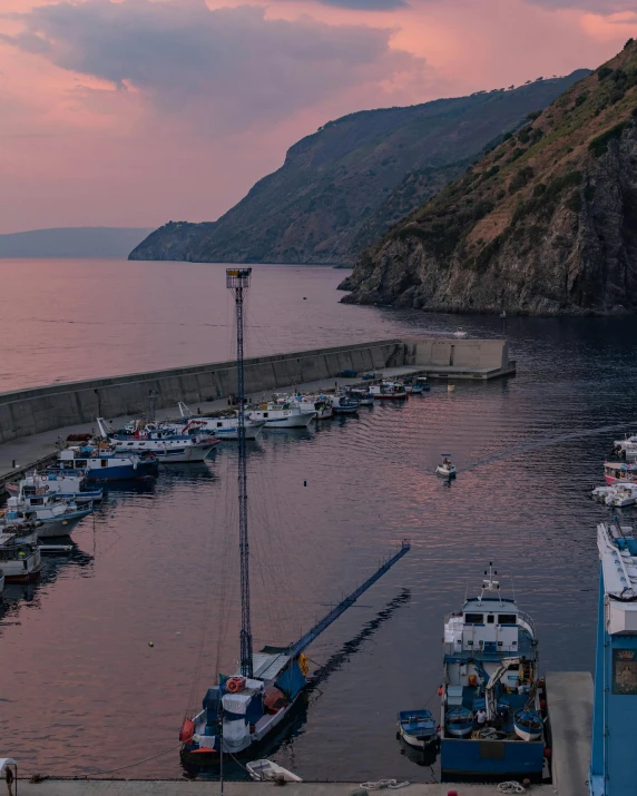 the boat harbor on the side of a hill is full of docked boats