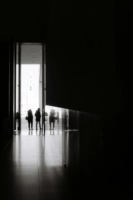 several people who are standing in front of a doorway