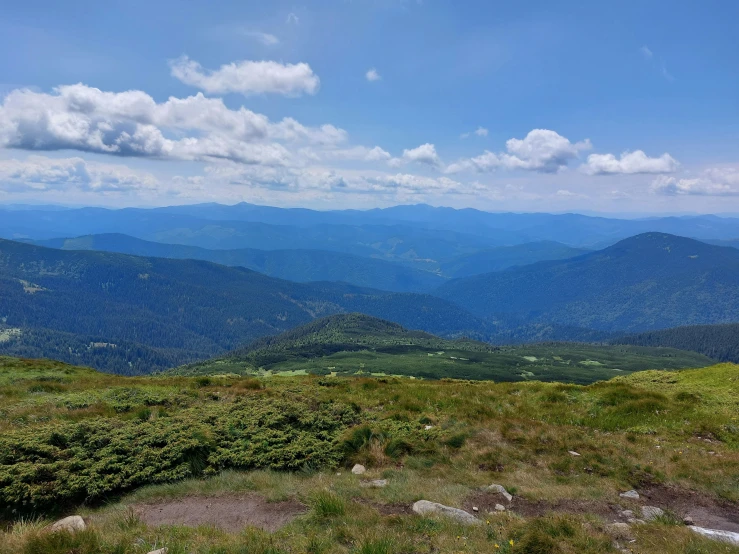 a view of mountains and grassy land during the day