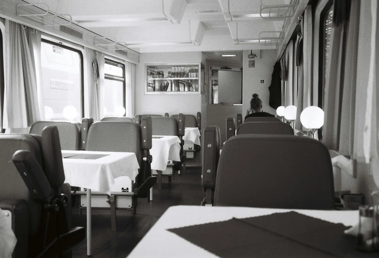 a woman sitting in the window seat of a train