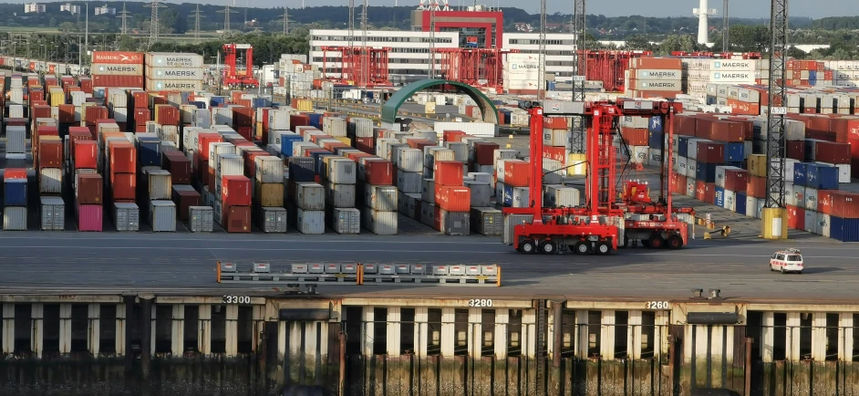 a big fork lift near some big containers