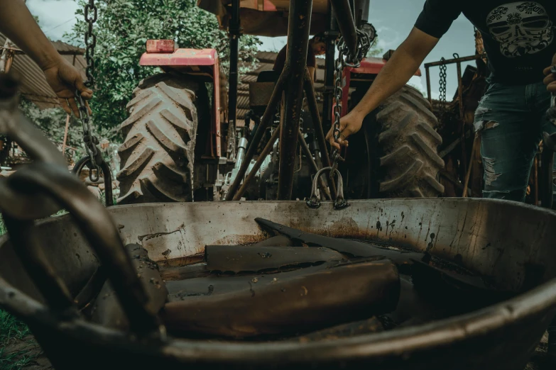 an old rusty tire and some large farm equipment