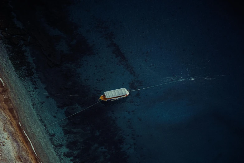 an aerial view of a small boat on the water