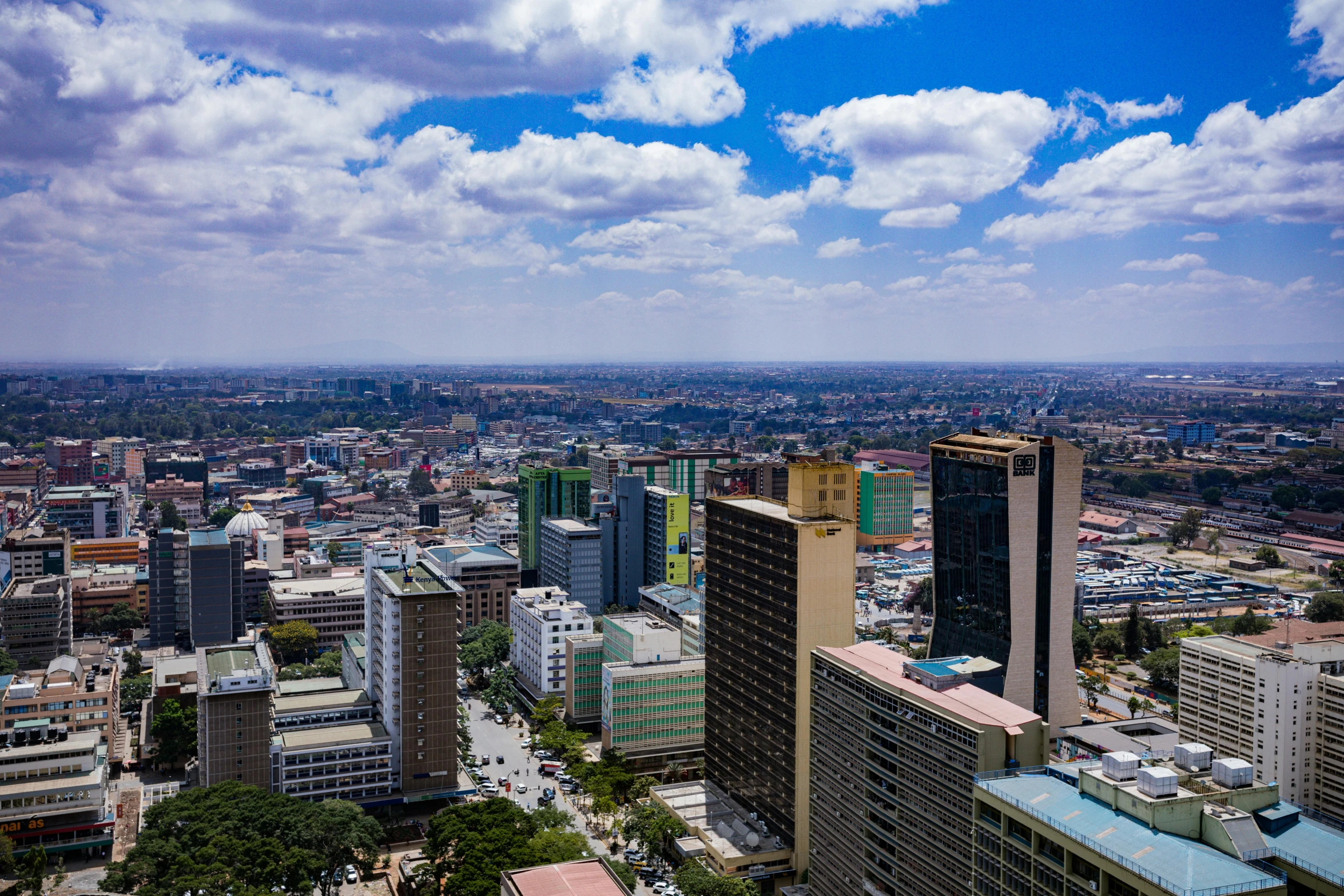 a large city with tall buildings under a blue sky