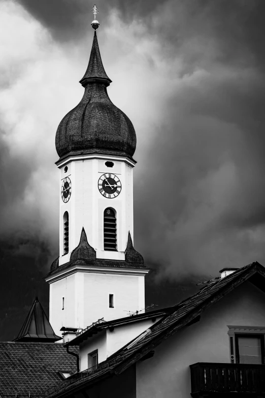 black and white pograph of a clock tower on the top of a building