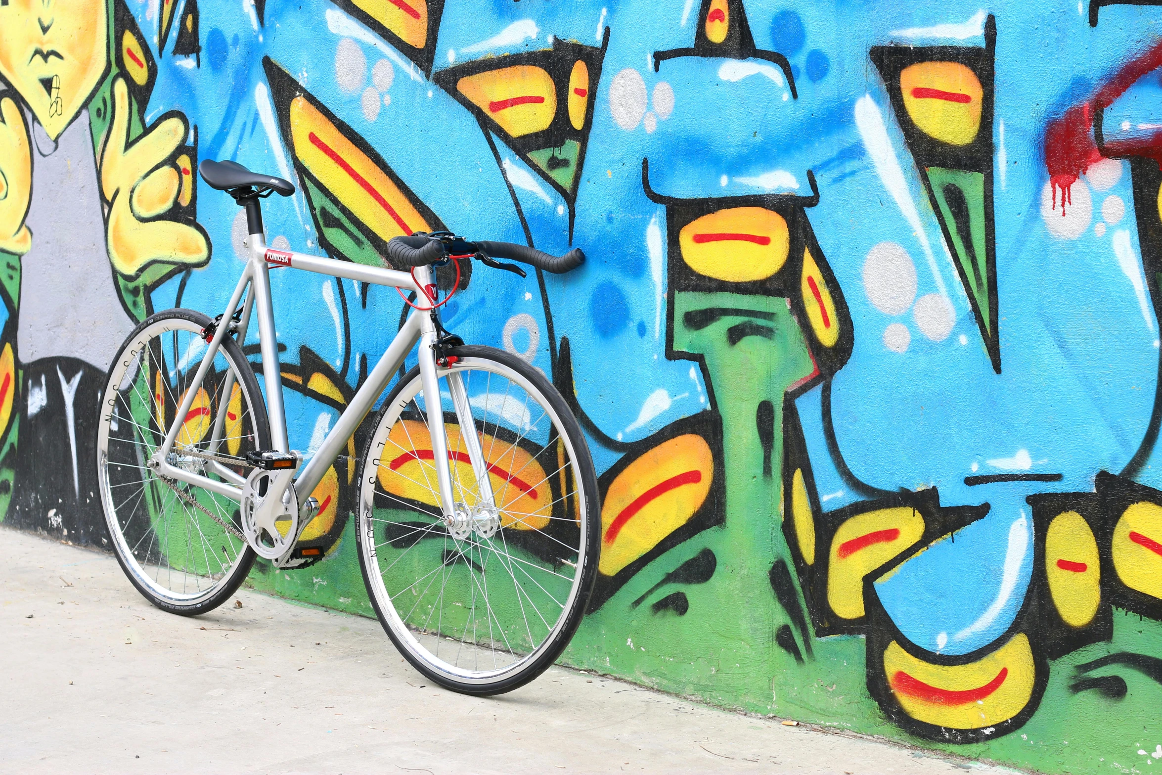 a bike leaning against a wall of graffiti