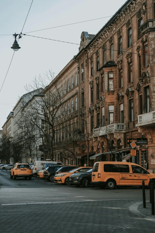 a line of taxis parked in front of building