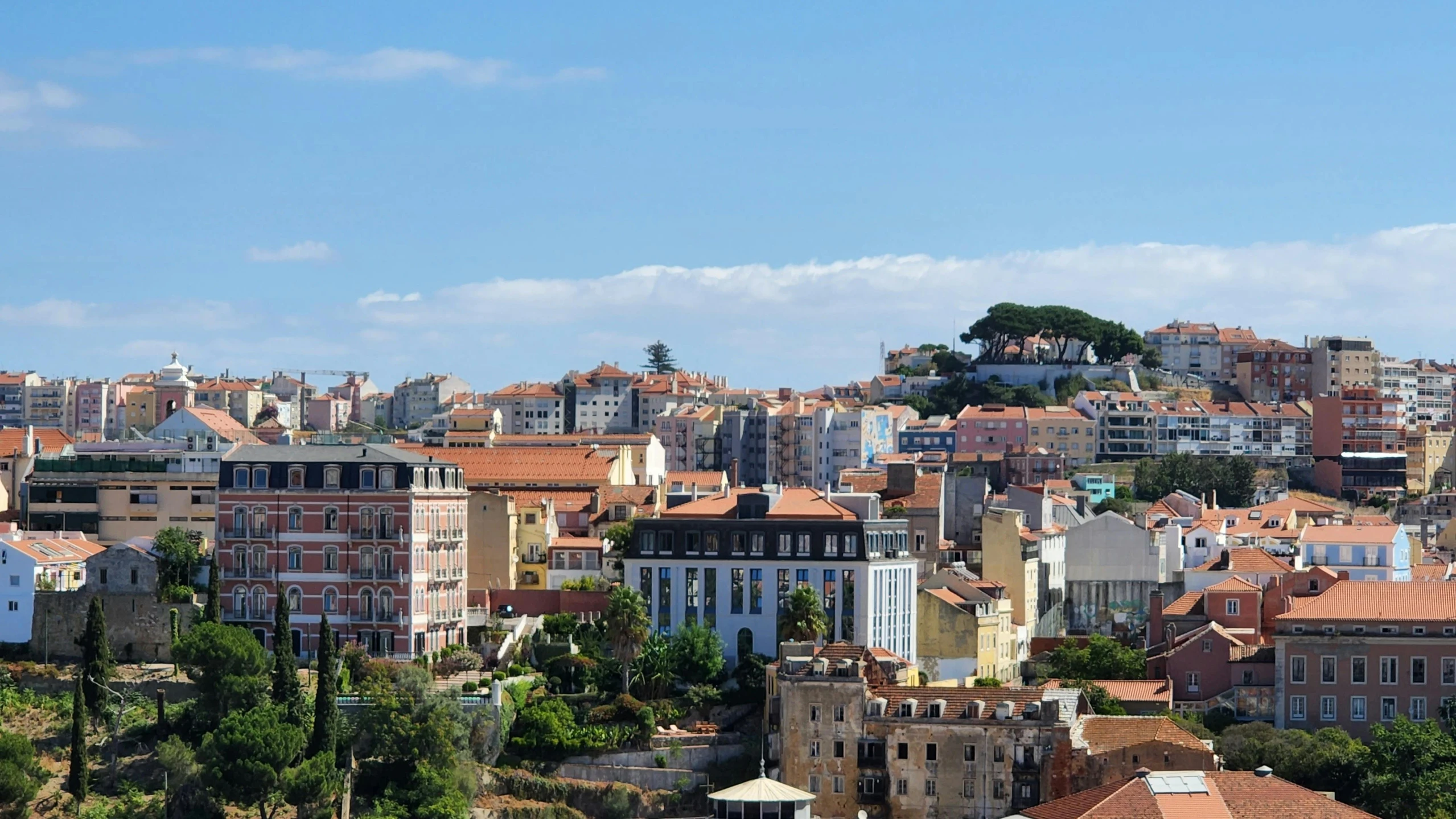 a city skyline with many buildings and a mountain in the distance