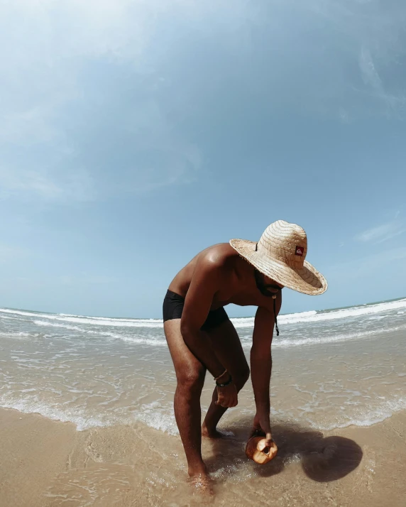 a young person standing on the sand at the beach