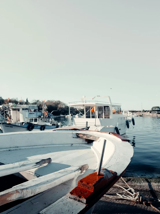 a couple of boats sitting next to the shore