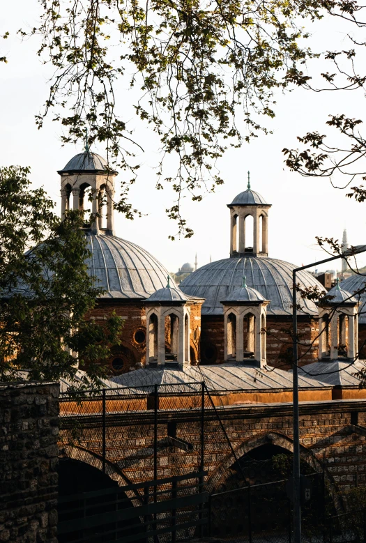 some white domes on top of two stone buildings