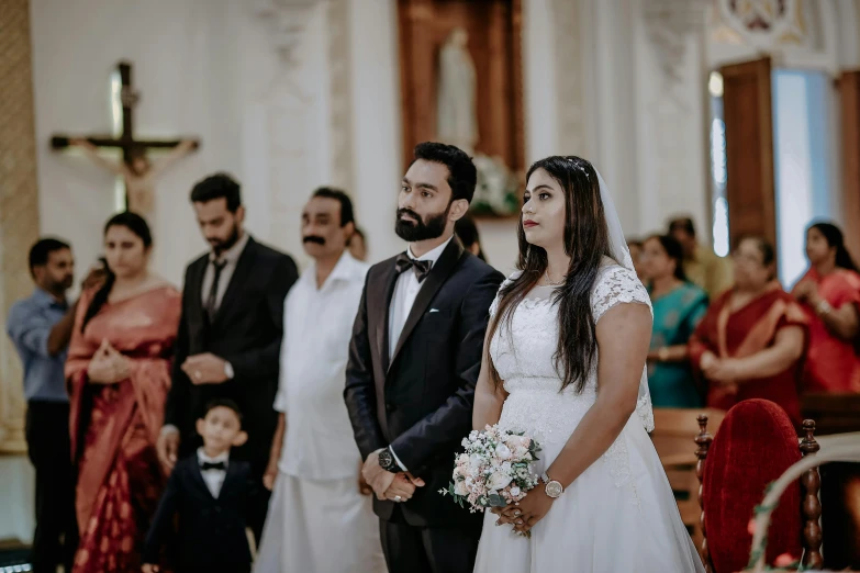 a bride and groom standing at the alter