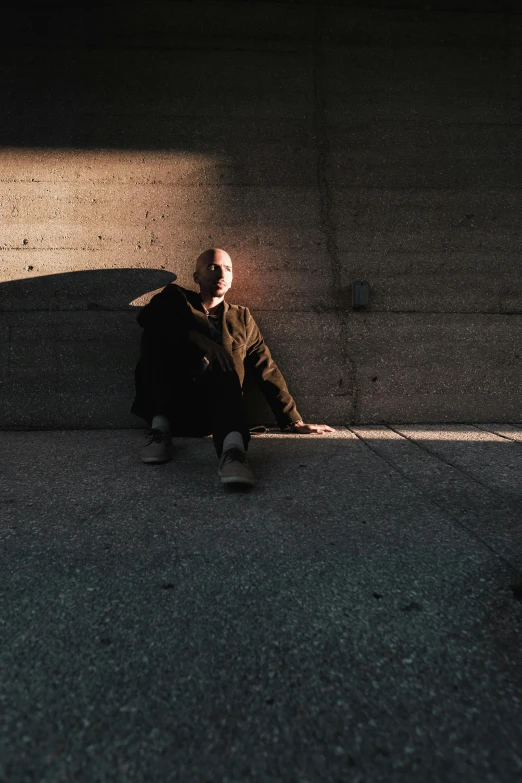 a person sitting on the ground with a cell phone