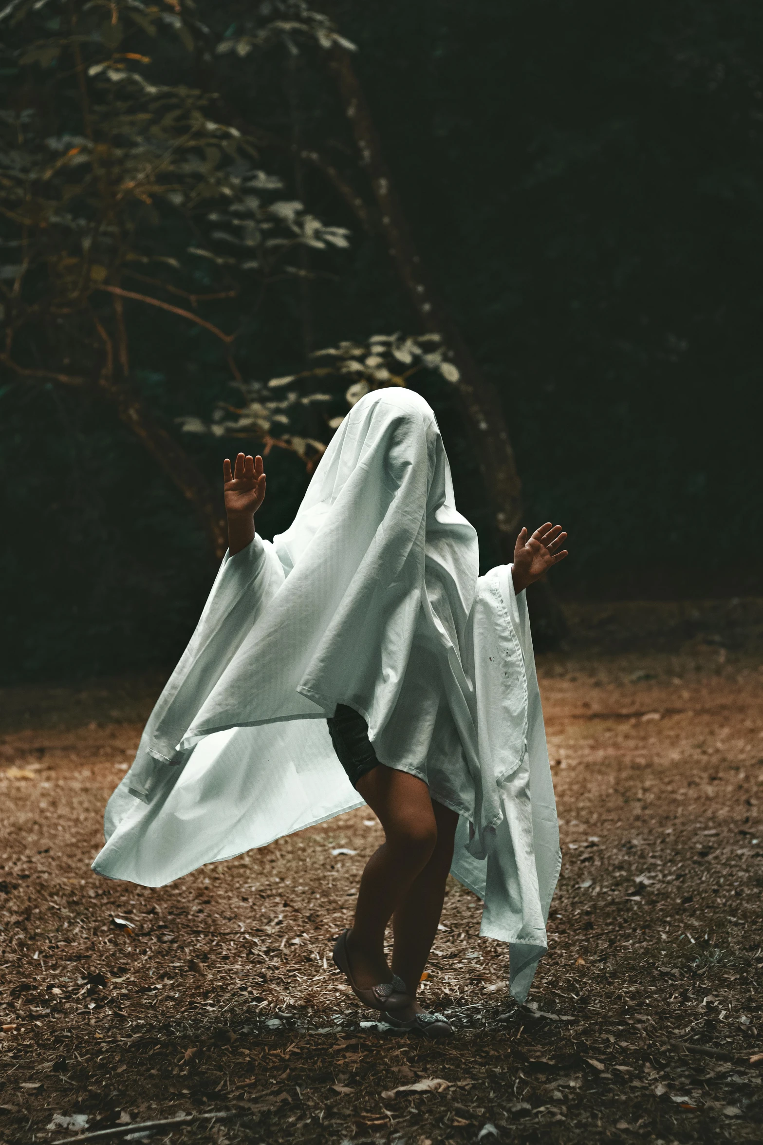 a woman walking in the middle of the woods