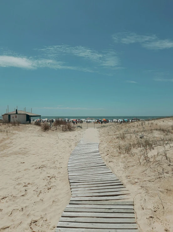 there is a pathway in the sand to a beach