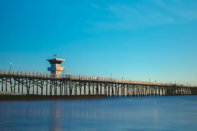 a large pier by the water in the distance