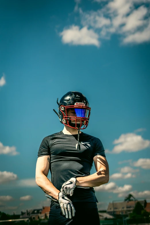 a person wearing a helmet and glove with a sky background