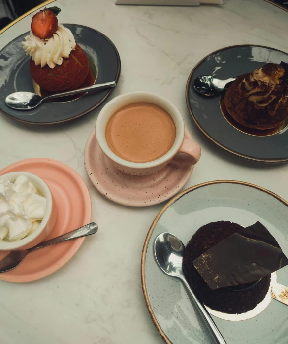 a white table with four different desserts on it