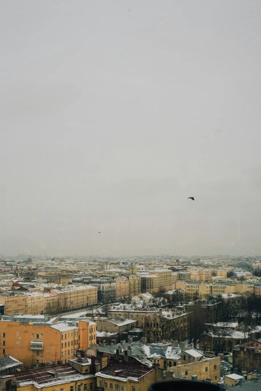 the view from an observation point at a city with many tall buildings and lots of snow