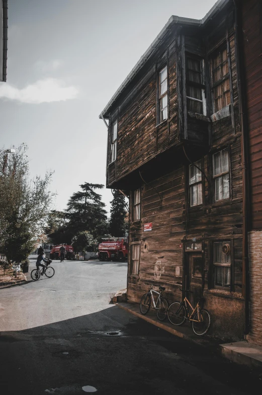 a street with cars, a bicycle, and an old building