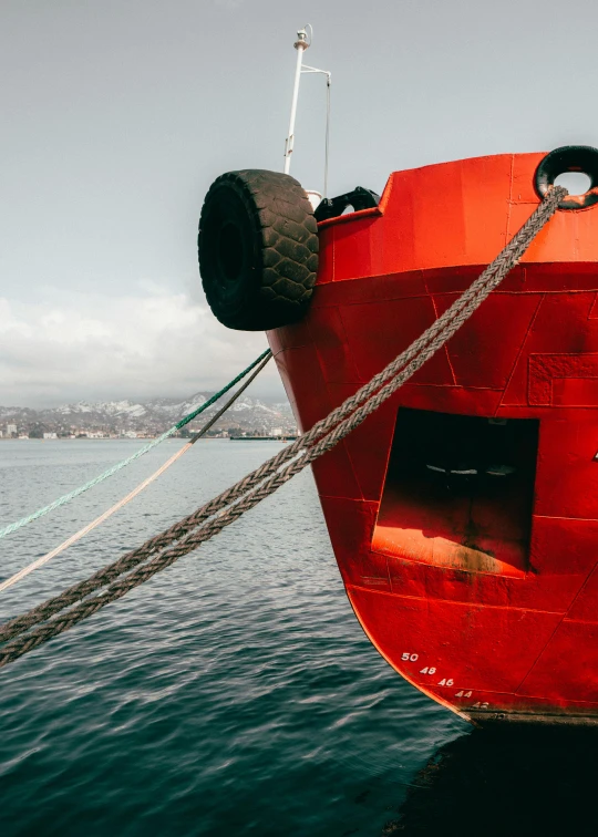 a large ship tied up to the dock with a rope