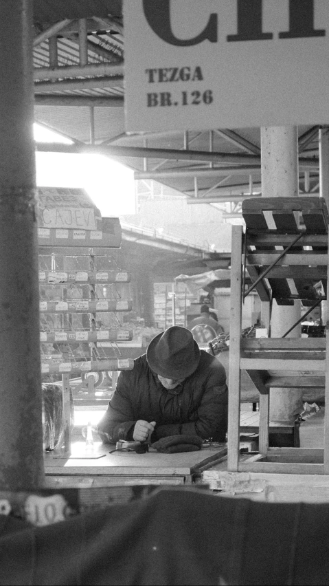 a man is sitting in front of a sign