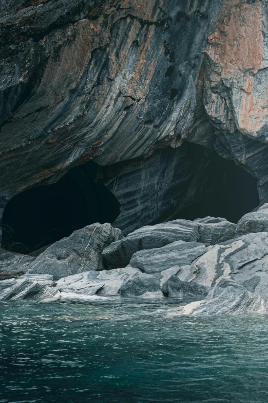 a cave with water and rocks around it