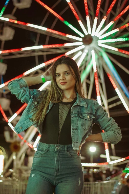 a woman standing in front of a colorful wheel