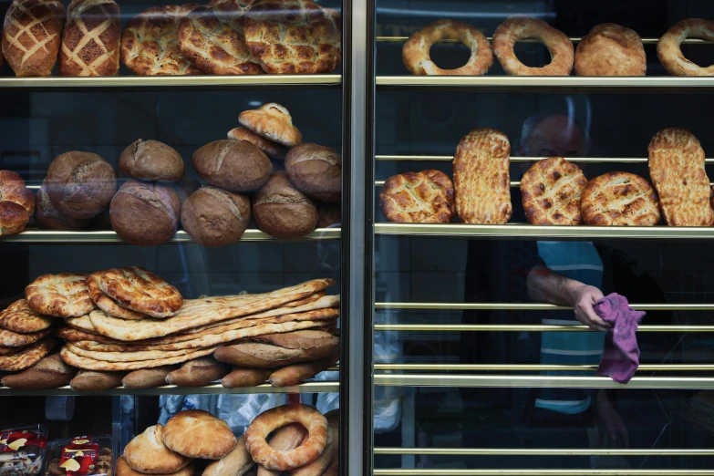 a bakery case with many different types of breads