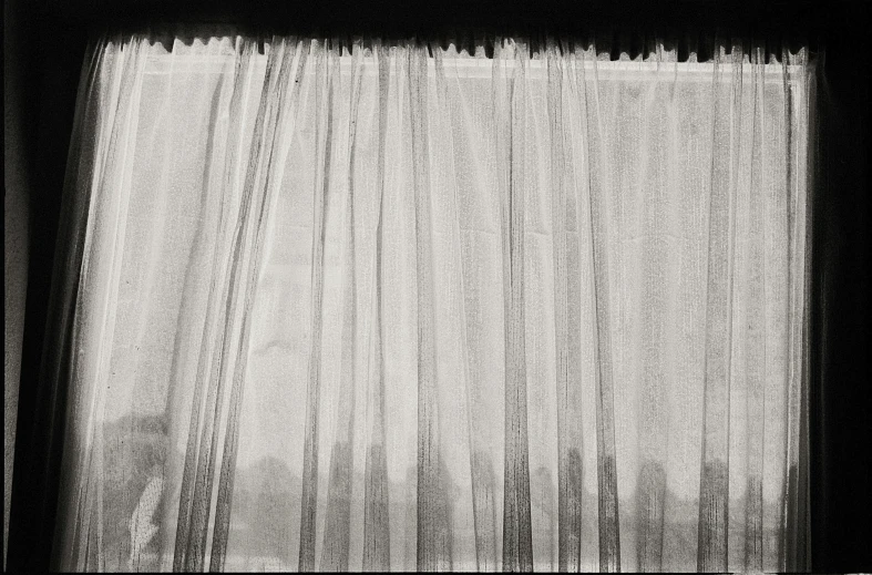 a black and white po of curtains and a window