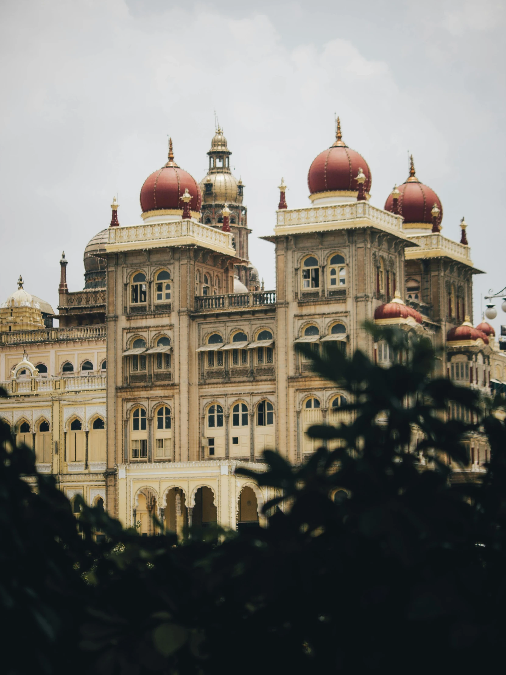 an ornate building that has red domes in it